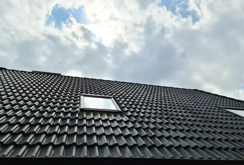 New tiled roof with a roof window completed by roofers in Wetherby
